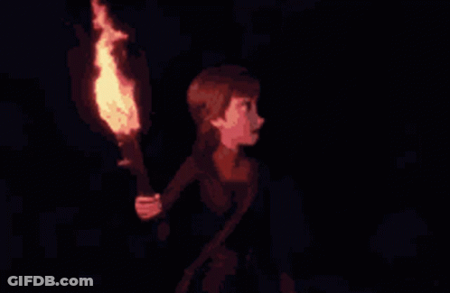 A Girl Is Holding A Torch In Her Hand In The Dark GIF
