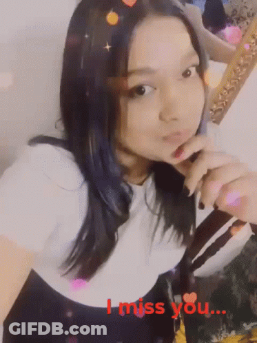 A Girl Is Holding Her Finger To Her Lips With The Words I Miss You Written In Red GIF