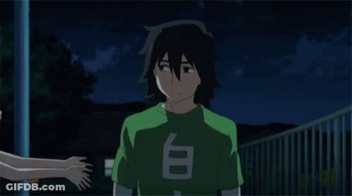 A Girl Is Hugging A Boy With A Green Shirt That Says T On It GIF
