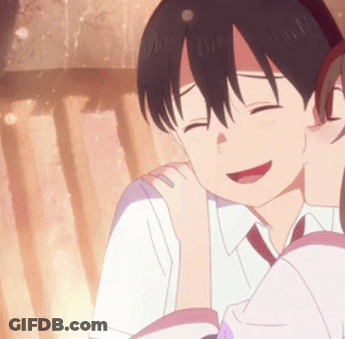 A Girl Is Kissing A Boy On The Cheek And They Are Smiling . GIF