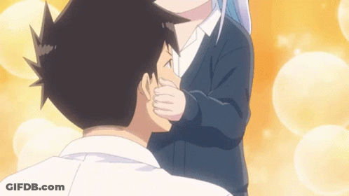 A Girl Is Kissing A Boy On The Cheek GIF