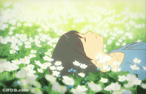 A Girl Is Laying In A Field Of Flowers With Her Eyes Closed GIF
