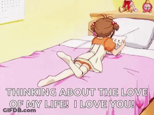 A Girl Is Laying On A Bed With Her Legs Crossed And Reading A Book . GIF