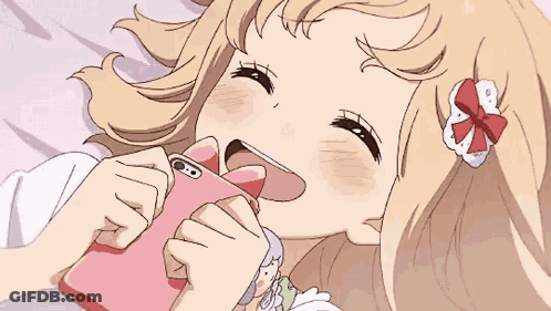 A Girl Is Laying On Her Stomach On A Bed In A Room GIF