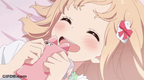 A Girl Is Laying On Her Stomach On A Bed GIF