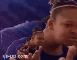 A Girl Is Making A Funny Face While Standing In Front Of A Purple Background . GIF