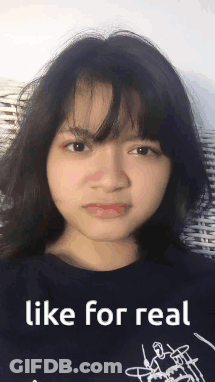 A Girl Is Making A Funny Face While Wearing A Black Shirt That Says Like For Real . GIF