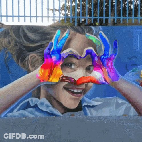 A Girl Is Making A Heart Shape With Her Hands GIF