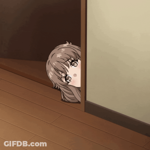 A Girl Is Peeking Out Of A Doorway And Looking At The Camera GIF