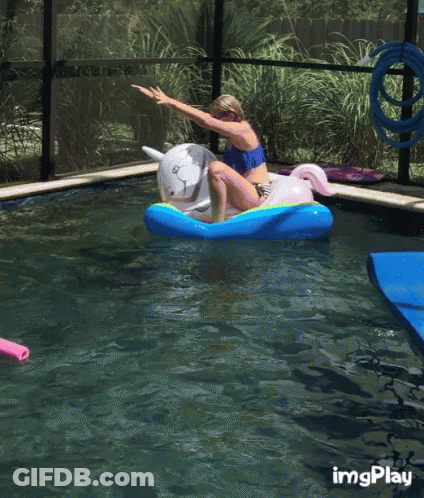 A Girl Is Riding A Unicorn Float In A Pool GIF