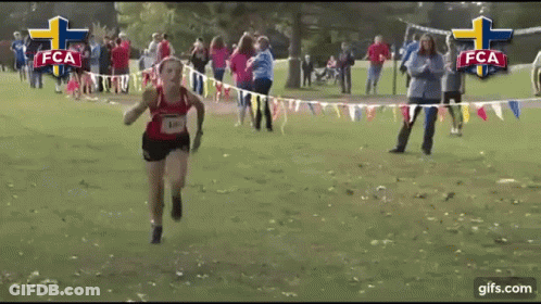 A Girl Is Running In A Race With The Letters Fca On The Bottom GIF