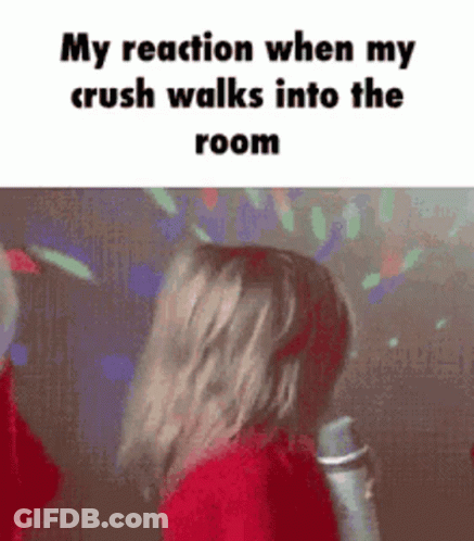 A Girl Is Singing Into A Microphone In A Room . GIF