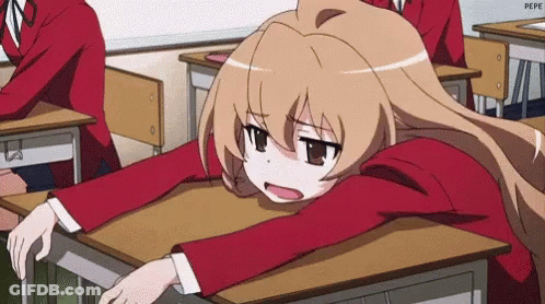 A Girl Is Sitting At A Desk In A Classroom With Her Head On The Desk . GIF