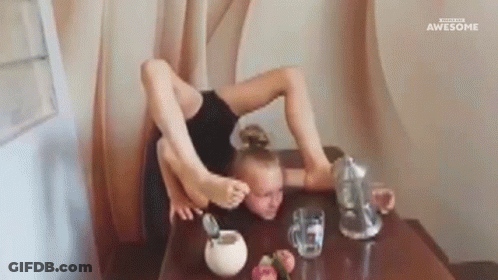 A Girl Is Sitting At A Table With Her Legs Crossed And A Pitcher Of Water . GIF