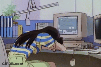 A Girl Is Sitting In Front Of A Computer With Her Head On The Desk GIF