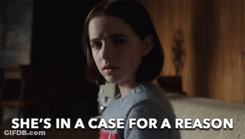 A Girl Is Sitting On A Couch With The Words She 'S In A Case For A Reason Above Her GIF