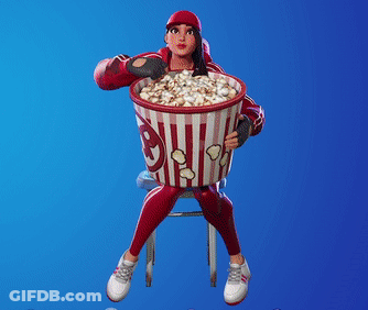 A Girl Is Sitting On A Stool Holding A Bucket Of Popcorn GIF