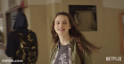 A Girl Is Smiling In A Hallway With A Netflix Logo In The Corner GIF