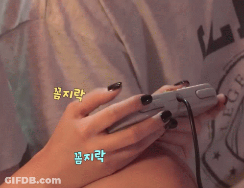 A Girl Is Smiling While Playing A Video Game GIF