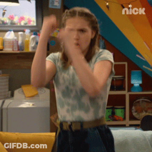A Girl Is Standing In Front Of A Nickelodeon Logo GIF