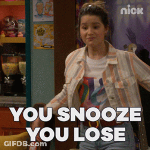 A Girl Is Standing In Front Of A Sign That Says Nick GIF