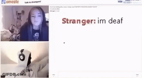 A Girl Is Standing In Front Of A Television In A Dark Room . GIF