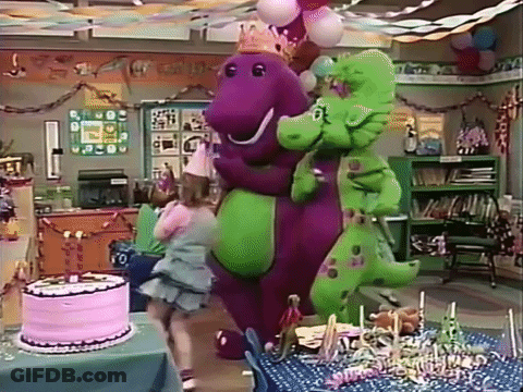A Girl Is Standing Next To A Purple And Green Dinosaur At A Birthday Party GIF