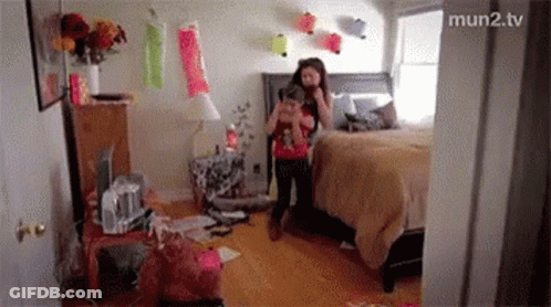 A Girl Is Taking A Picture Of Herself In A Messy Bedroom GIF