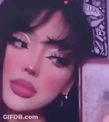 A Girl Is Taking A Selfie In Front Of A Mirror . GIF