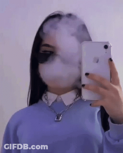 A Girl Is Taking A Selfie With Her Phone While Smoking A Cigarette . GIF