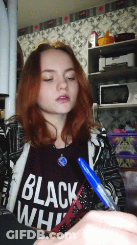 A Girl Is Wearing A Black Shirt That Says Black White GIF