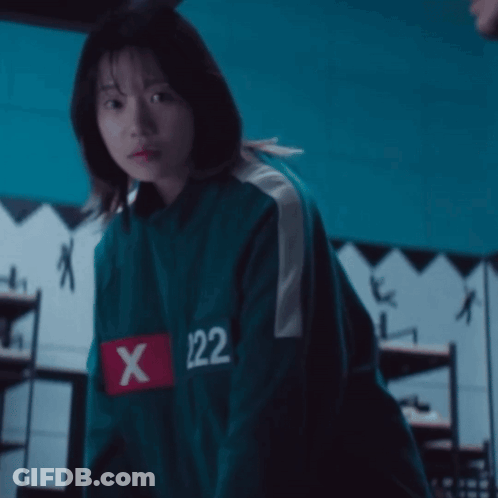 A Girl Is Wearing A Green Jacket With The Number 122 On The Sleeve GIF