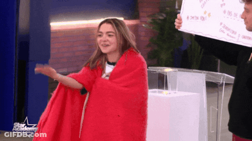 Girl Wrapped In Red Blanket With Star Academy Sign GIF