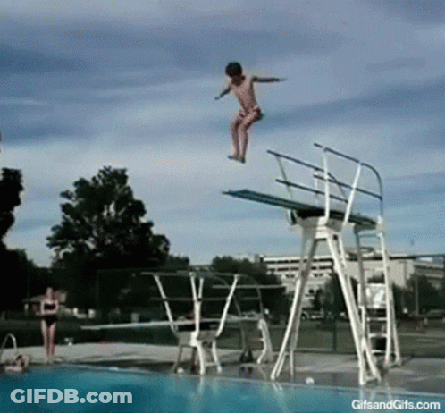 A Girl Jumps Off A Diving Board Into A Swimming Pool GIF