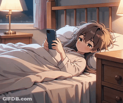 A Girl Laying On A Bed Looking At Her Phone GIF