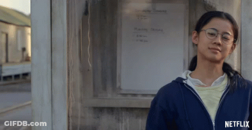A Girl Leaning Against A Wall With A Netflix Logo On The Bottom Right GIF