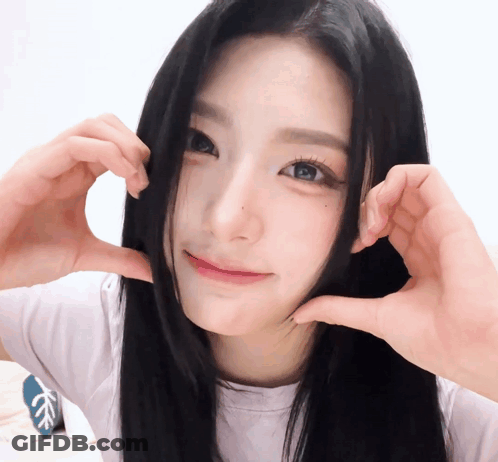 A Girl Making A Heart Shape With Her Hands GIF