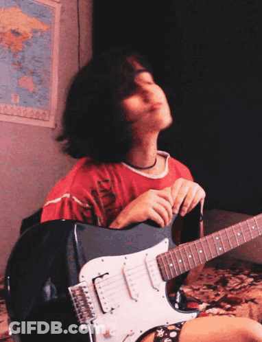 A Girl Playing An Electric Guitar In Front Of A Map GIF