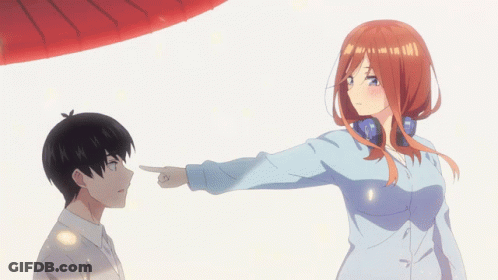A Girl Pointing At A Boy In A Blue Shirt GIF