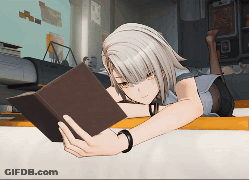 A Girl Reading A Book While Laying On A Table GIF