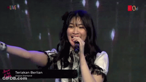A Girl Singing Into A Microphone With The Words Teriak Berlian On The Bottom Right GIF