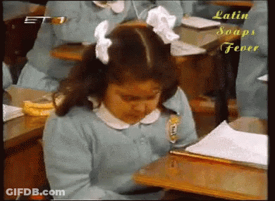 A Girl Sits At A Desk In A Classroom With Latin Soaps Fever Written On The Bottom Right GIF