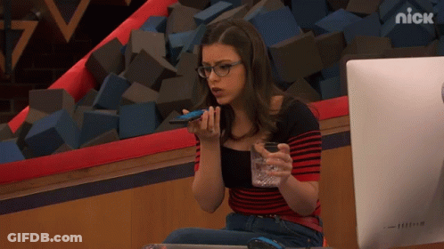 A Girl Sitting In Front Of A Computer With The Nick Logo On The Bottom Right GIF