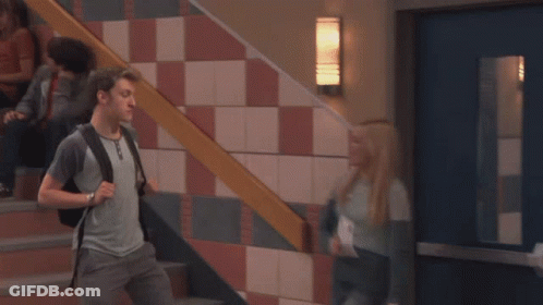 A Girl Standing In Front Of A Row Of Blue Lockers With Her Mouth Open GIF