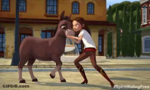 A Girl Standing Next To A Donkey With The Hashtag Spiritridingfree GIF