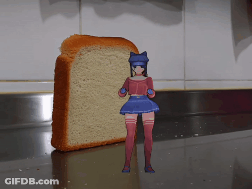 A Girl Standing Next To A Loaf Of Bread On A Counter GIF