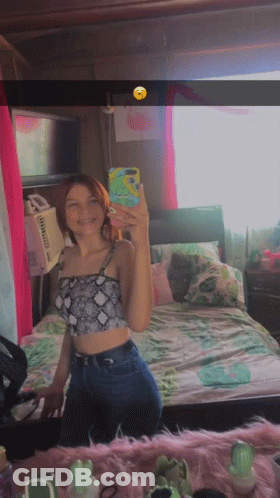 A Girl Taking A Selfie In Front Of A Mirror GIF