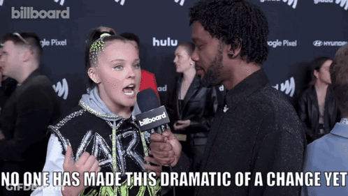 A Girl Talking Into A Billboard Microphone GIF