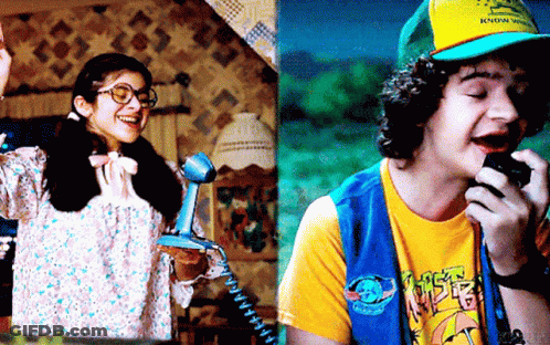 A Girl Talking On A Phone Next To A Boy Talking Into A Microphone GIF