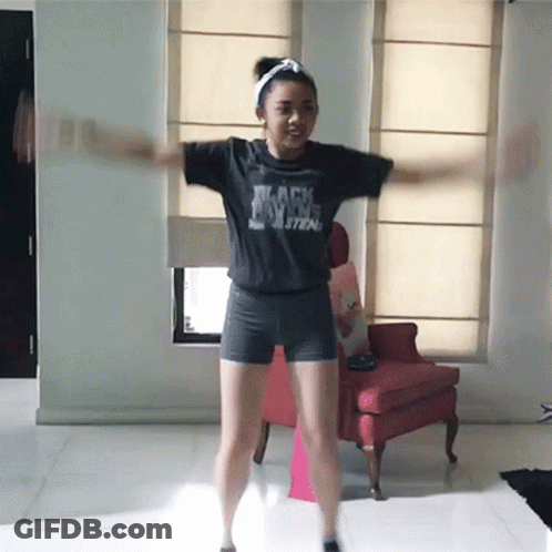A Girl Wearing A Black Shirt That Says " Black Magic " GIF